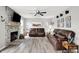 Inviting living room features a stone fireplace, ceiling fan, and comfortable leather seating for relaxing at home at 5595 Auburndale Dr, Bargersville, IN 46106