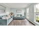Bright living room with stylish furniture, a decorative mirror, and natural light from large windows at 5595 Auburndale Dr, Bargersville, IN 46106