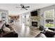 Open concept floor plan with a stone fireplace, living room furniture, and kitchen in the background at 5595 Auburndale Dr, Bargersville, IN 46106