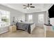 Spacious main bedroom with a tray ceiling, two windows, neutral carpeting and a large, comfortable bed at 5595 Auburndale Dr, Bargersville, IN 46106