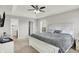 Comfortable main bedroom with carpet, a tray ceiling, large windows, and a view into an en suite bathroom at 5595 Auburndale Dr, Bargersville, IN 46106