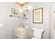 Traditional half-bathroom with patterned wallpaper, vanity with storage, and classic fixtures at 5927 Pine Hill Dr, Indianapolis, IN 46235