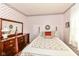 Bedroom with floral wallpaper, a four poster bed, and a vintage dresser at 5927 Pine Hill Dr, Indianapolis, IN 46235