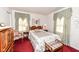 Cozy bedroom featuring a wood bed frame, matching furnishings, and two windows at 5927 Pine Hill Dr, Indianapolis, IN 46235