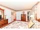 Warm bedroom featuring soft floral bedding, complemented by a classic wooden dresser and ample closet space at 5927 Pine Hill Dr, Indianapolis, IN 46235