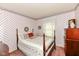 Bedroom features a floral wallpaper, a four poster bed, and a chest of drawers at 5927 Pine Hill Dr, Indianapolis, IN 46235
