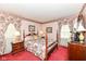 Charming bedroom with floral accents, featuring a four-poster bed and matching nightstands for a cozy feel at 5927 Pine Hill Dr, Indianapolis, IN 46235