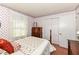 Bedroom features floral wallpaper, a bed, and a built-in closet at 5927 Pine Hill Dr, Indianapolis, IN 46235