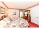 Inviting bedroom with floral wallpaper, featuring a four-poster bed and vintage-style dresser at 5927 Pine Hill Dr, Indianapolis, IN 46235