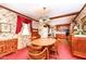 Traditional dining room featuring a wood table, chairs, and vintage wallpaper with access to the kitchen at 5927 Pine Hill Dr, Indianapolis, IN 46235
