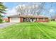 Charming single-story brick home featuring a well-maintained lawn and an attached two-car garage at 5927 Pine Hill Dr, Indianapolis, IN 46235