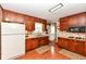 Traditional kitchen features wood cabinets, laminate counters, and a white refrigerator at 5927 Pine Hill Dr, Indianapolis, IN 46235