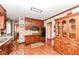 Functional kitchen featuring wood cabinets, laminate countertops, and essential appliances, including double oven at 5927 Pine Hill Dr, Indianapolis, IN 46235