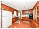 Functional kitchen with classic wood cabinets, laminate countertops, and essential appliances at 5927 Pine Hill Dr, Indianapolis, IN 46235