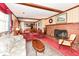 Open living room with brick fireplace and view into the dining room at 5927 Pine Hill Dr, Indianapolis, IN 46235