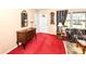Classic living room design with patterned wallpaper, traditional furniture, and large window at 5927 Pine Hill Dr, Indianapolis, IN 46235