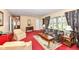 Spacious living room features classic furniture, plush carpeting, and a bright window for natural light at 5927 Pine Hill Dr, Indianapolis, IN 46235