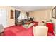 Cozy living room with a large window, plush red carpeting and comfortable seating arrangement at 5927 Pine Hill Dr, Indianapolis, IN 46235
