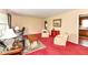 Comfortable living room with classic furnishings, leading to the kitchen area, with plush red carpeting at 5927 Pine Hill Dr, Indianapolis, IN 46235