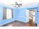 Bedroom boasts a ceiling fan, hardwood floors, base-board heating, and an access door at 6017 E 52Nd Pl, Indianapolis, IN 46226