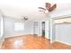 Large bedroom with hardwood floors, open closets, ceiling fans, and easy access to other levels at 6017 E 52Nd Pl, Indianapolis, IN 46226