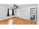 Spacious bedroom features hardwood floors, a ceiling fan, and access to a private bathroom at 6017 E 52Nd Pl, Indianapolis, IN 46226