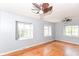 Bright bedroom features original hardwood floors and multiple windows for ample natural light at 6017 E 52Nd Pl, Indianapolis, IN 46226