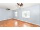 Large bedroom featuring hardwood floors, ceiling fans, and multiple windows offering plenty of natural light at 6017 E 52Nd Pl, Indianapolis, IN 46226
