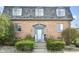 Charming brick facade of a two-story condominium with a well-manicured front entrance and dormer windows at 6017 E 52Nd Pl, Indianapolis, IN 46226