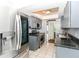 Spacious kitchen features stainless steel appliances, gray cabinets and access to the rest of the house at 6017 E 52Nd Pl, Indianapolis, IN 46226