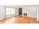 Bright living room with hardwood floors, a decorative fireplace, and a large window for natural light at 6017 E 52Nd Pl, Indianapolis, IN 46226