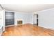Living room with hardwood floors, fireplace, built-in shelving, and access to other rooms at 6017 E 52Nd Pl, Indianapolis, IN 46226