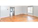 Living room shows hardwood floors, base-board heating, and large window letting in natural light at 6017 E 52Nd Pl, Indianapolis, IN 46226