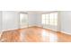Spacious living room shows hardwood floors, base-board heating, and natural lighting at 6017 E 52Nd Pl, Indianapolis, IN 46226