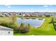 Community with pond and manicured lawns, creating a serene and inviting atmosphere at 621 Sonoma Ln, Greenfield, IN 46140