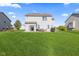 Expansive backyard with a well-maintained lawn, patio, grill, and cozy outdoor seating area at 621 Sonoma Ln, Greenfield, IN 46140