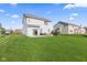 Spacious backyard featuring lush green grass and a patio with outdoor furniture for entertaining at 621 Sonoma Ln, Greenfield, IN 46140