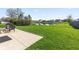 Landscaped backyard features a serene pond view, patio, seating area, and lush greenery at 621 Sonoma Ln, Greenfield, IN 46140