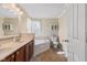 Bright bathroom features double sinks, a soaking tub, a toilet, and a shower at 621 Sonoma Ln, Greenfield, IN 46140