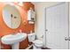 Well lit half bathroom with pedestal sink and wood look flooring at 621 Sonoma Ln, Greenfield, IN 46140