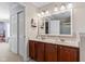 Bathroom features double sinks, wood cabinets, a large mirror and access to multiple rooms at 621 Sonoma Ln, Greenfield, IN 46140