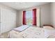 Cozy bedroom with closet, window with red curtains, and comfortable bed at 621 Sonoma Ln, Greenfield, IN 46140