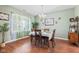 Cozy dining room featuring natural light, wood floors and a decorative chandelier at 621 Sonoma Ln, Greenfield, IN 46140