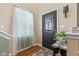 Welcoming foyer featuring a decorative front door, stylish rug and a side table with a plant at 621 Sonoma Ln, Greenfield, IN 46140