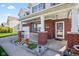 Inviting front porch with brick pillars, white railing, and decorative flower pots at 621 Sonoma Ln, Greenfield, IN 46140