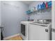 Well-lit laundry room with modern washer and dryer, convenient shelving, and organized supplies at 621 Sonoma Ln, Greenfield, IN 46140