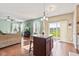 Bright living room with a view of a lake, a dark island, and a sliding glass door at 621 Sonoma Ln, Greenfield, IN 46140