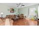 Spacious living room with hardwood floors, natural light, and a ceiling fan at 621 Sonoma Ln, Greenfield, IN 46140