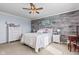 Comfortable bedroom features a ceiling fan, light colored walls and carpet, and a wooden accent wall at 621 Sonoma Ln, Greenfield, IN 46140