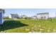 Large grassy backyard surrounded by neighboring homes and black metal fencing on a sunny day at 6408 Askin Dr, Indianapolis, IN 46259